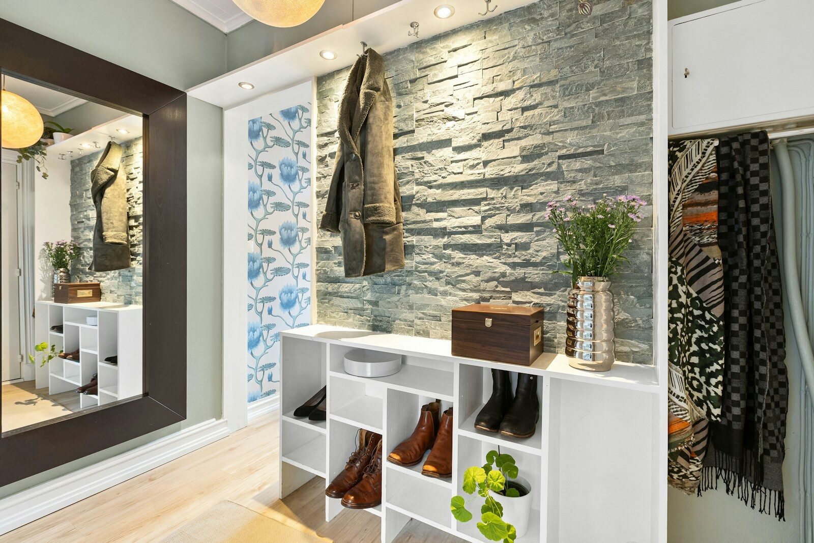 A room with a mirror and a shelf with shoes on it
