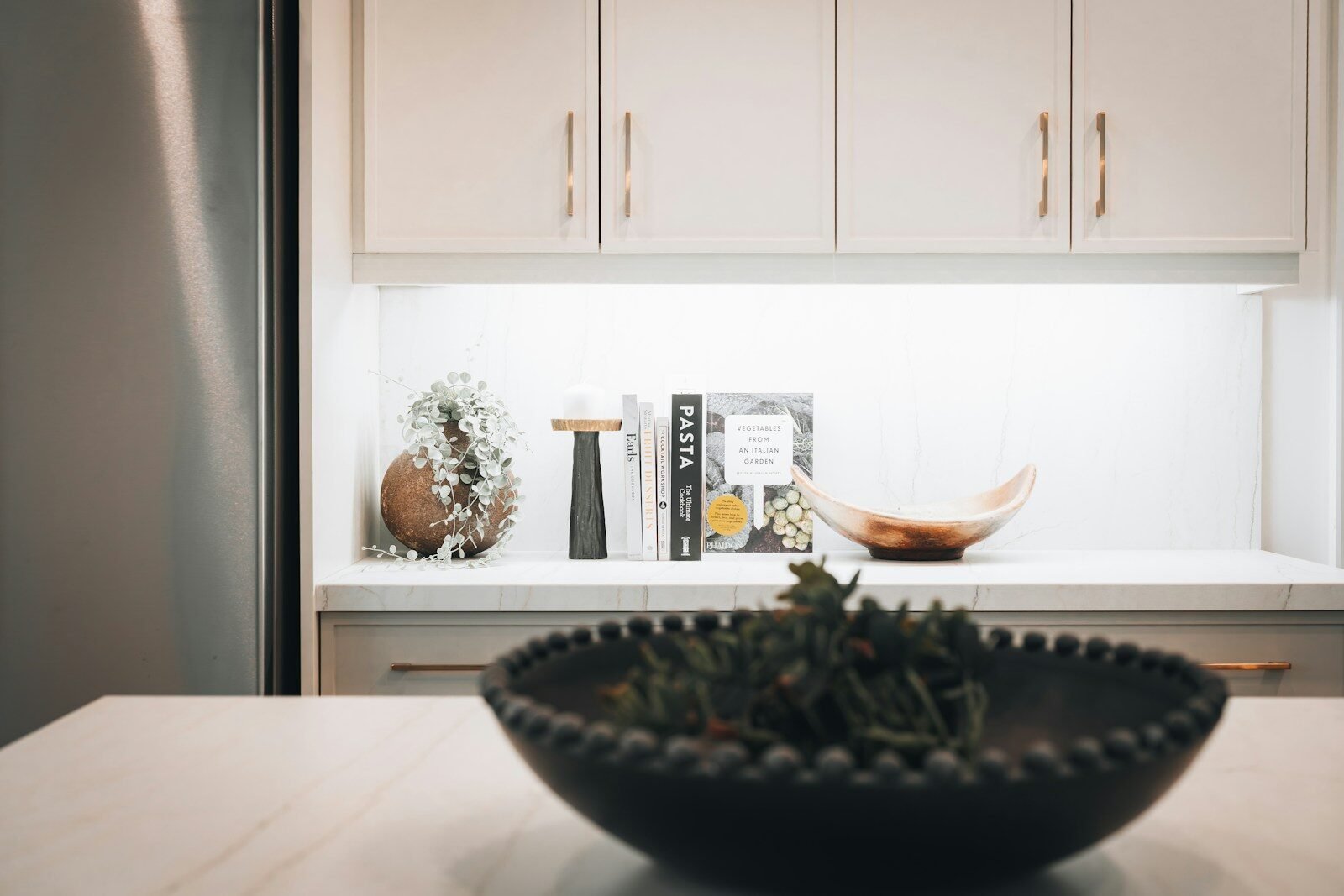 Modern kitchen counter with decorative items and cabinets