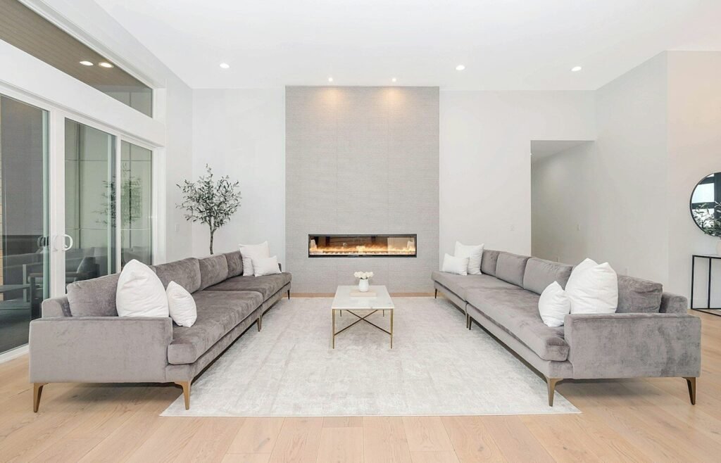 Two grey velvet sofas facing each other in a bright modern living room