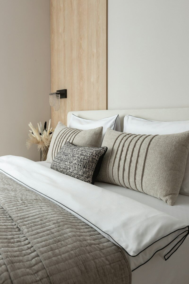Modern bedroom with neutral-toned pillows and bedding