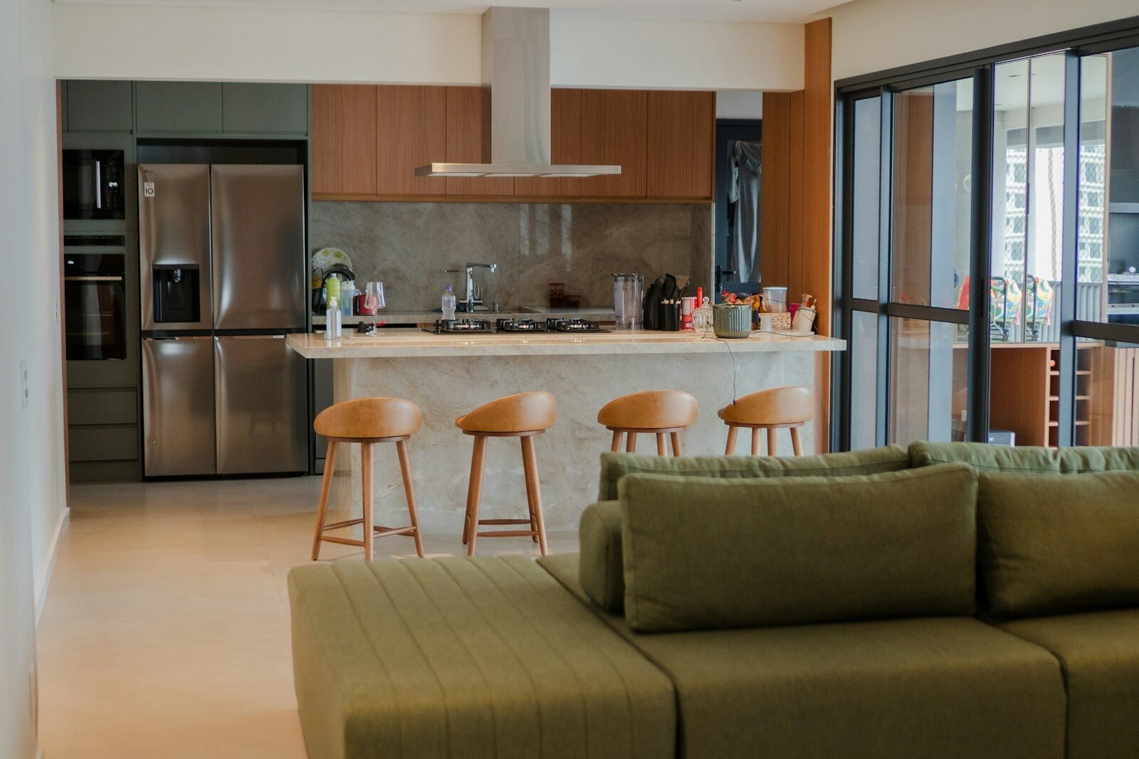 Modern open-plan living room and kitchen with green sofa