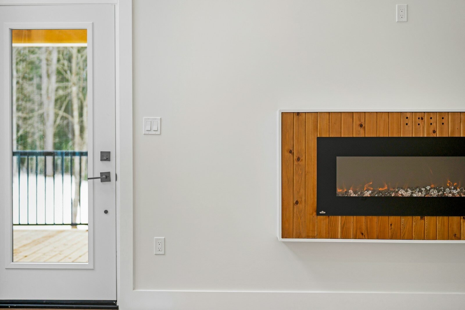 Modern electric fireplace with wood trim on wall